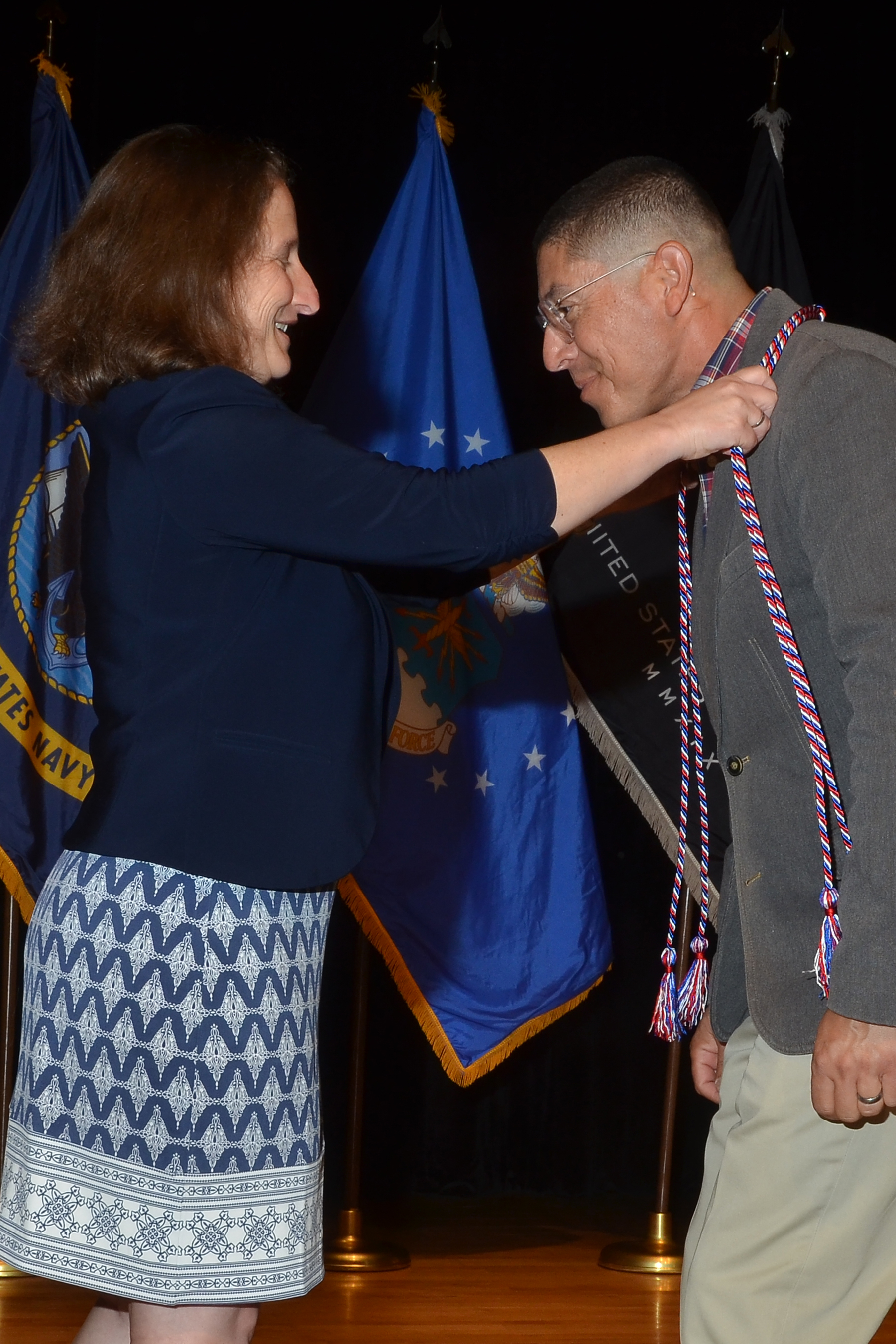 Student veteran being presented with an honor cord.