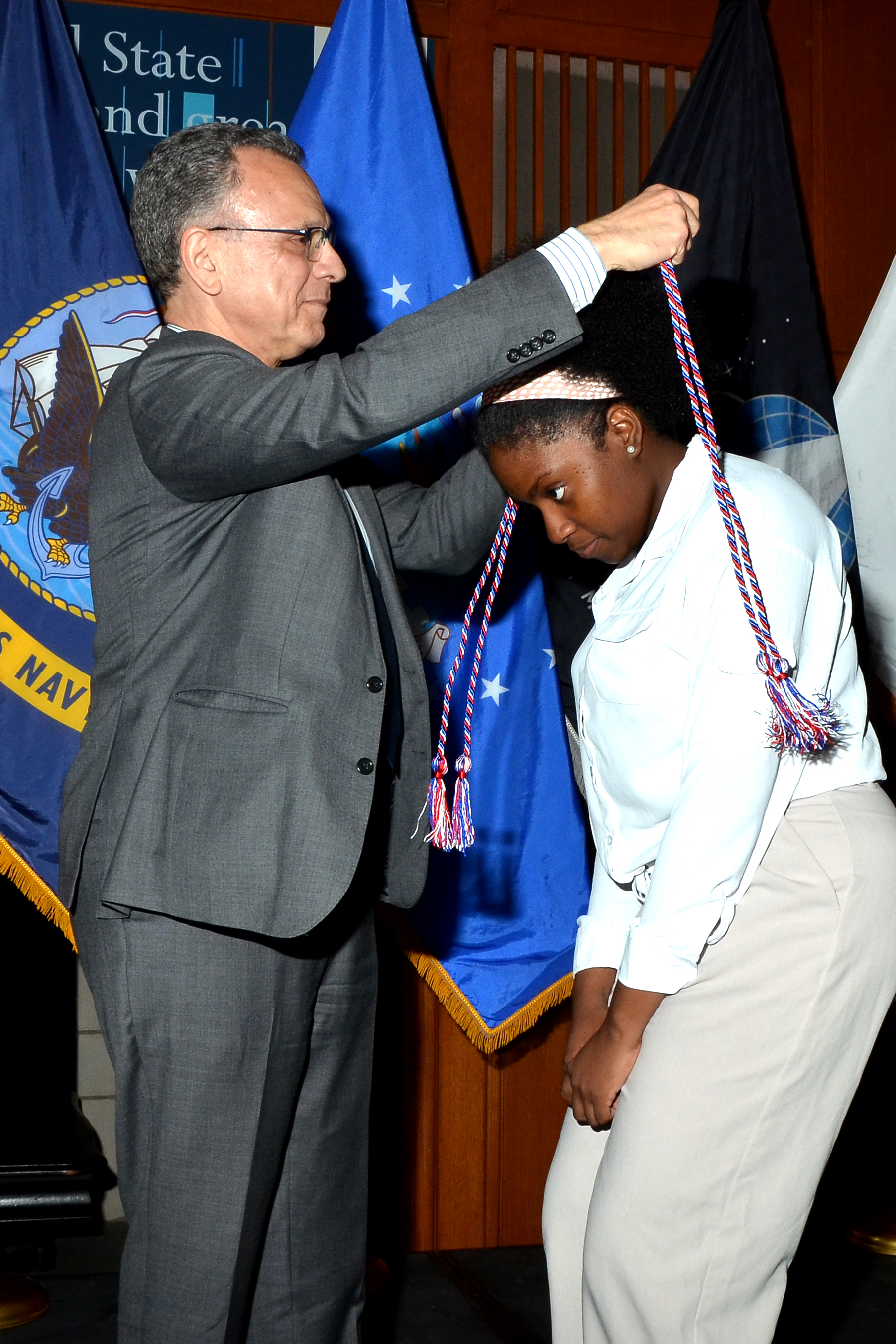 Images in this gallery show graduating student veterans and service members being presented with a military honor cord.